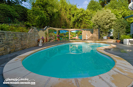 Aménagement paysager d'une piscine. fresque décorative en&nbsp; trompe-l'œil peinte pour l'habillage de ce mur de jardin. Thème exotique
