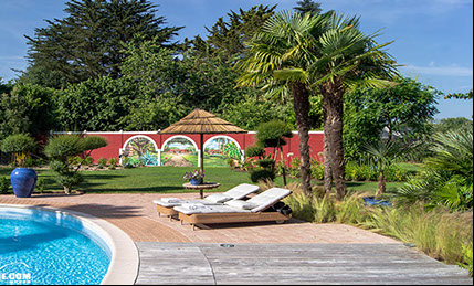 Habillage du murl des abords d'une piscine privative dans un jardin exotique à Quimper dans le Finistère en Bretagne.